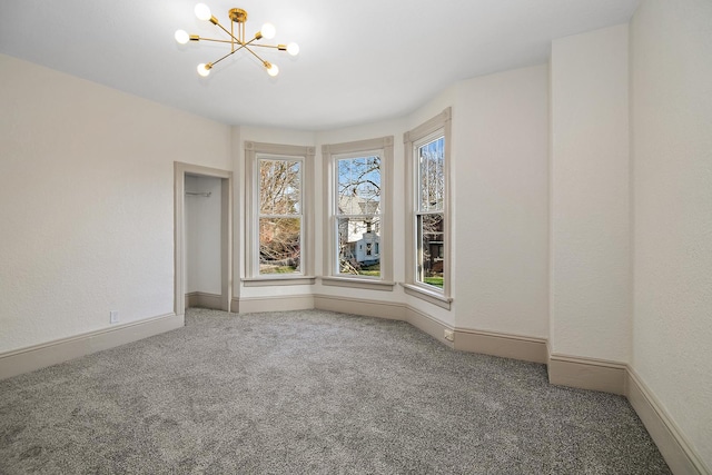 505 S Indiana Ave, Kankakee, IL 60901 - carpeted empty room with a chandelier and baseboards