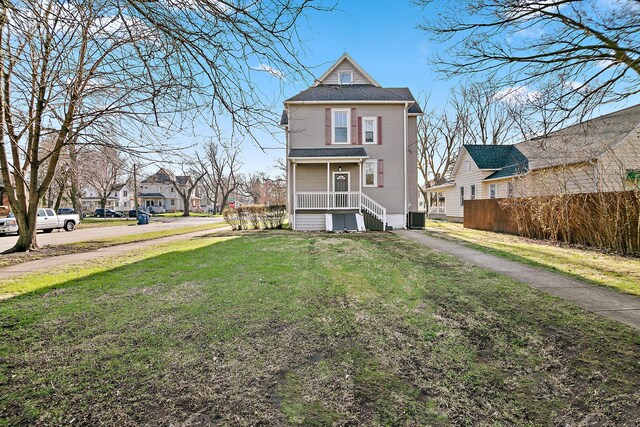 505 S Indiana Ave, Kankakee, IL 60901 - back of house with central AC unit, fence, a residential view, and a lawn