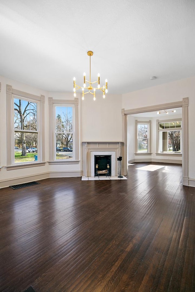 505 S Indiana Ave, Kankakee, IL 60901 - unfurnished living room with a chandelier, visible vents, wood-type flooring, and plenty of natural light