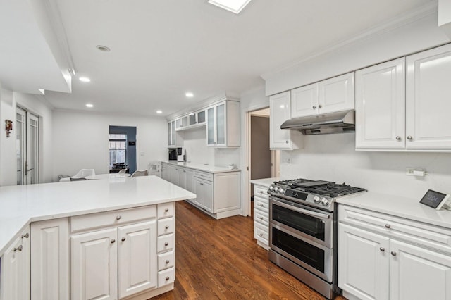 kitchen featuring range with two ovens, dark wood finished floors, white cabinets, under cabinet range hood, and recessed lighting