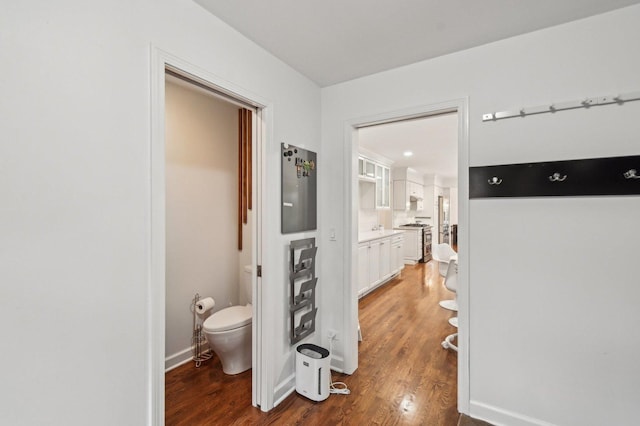 bathroom featuring baseboards, toilet, and wood finished floors