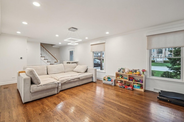 living room featuring recessed lighting, stairs, crown molding, and wood finished floors