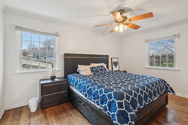 bedroom with a ceiling fan, baseboards, ornamental molding, and wood finished floors