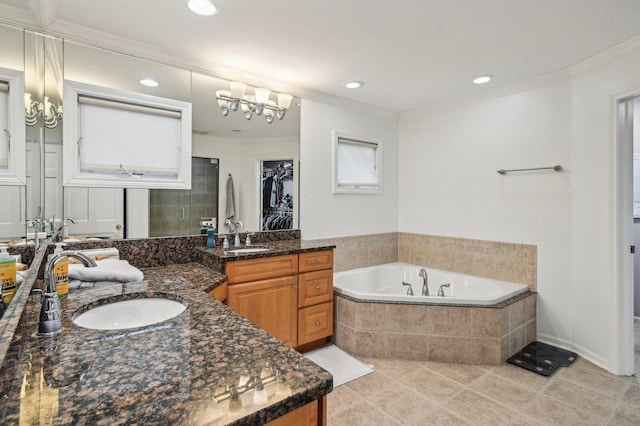 bathroom featuring tile patterned flooring, a sink, crown molding, and a bath