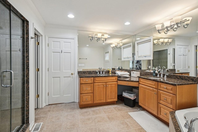 bathroom with a sink, crown molding, a shower stall, and a notable chandelier