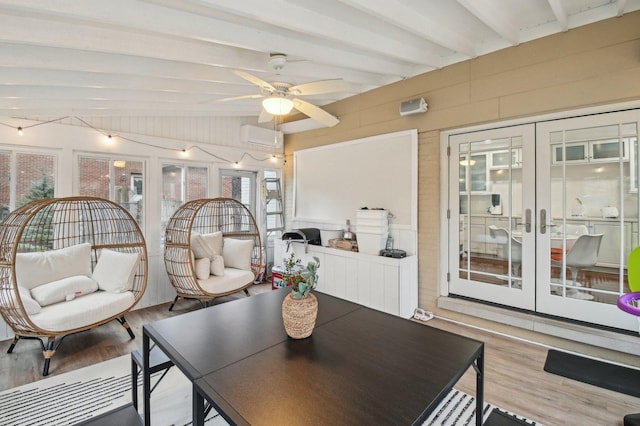 interior space featuring beam ceiling, a wall mounted AC, and french doors