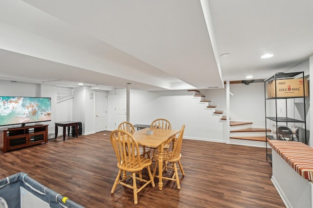 dining room featuring recessed lighting, baseboards, wood finished floors, and stairway