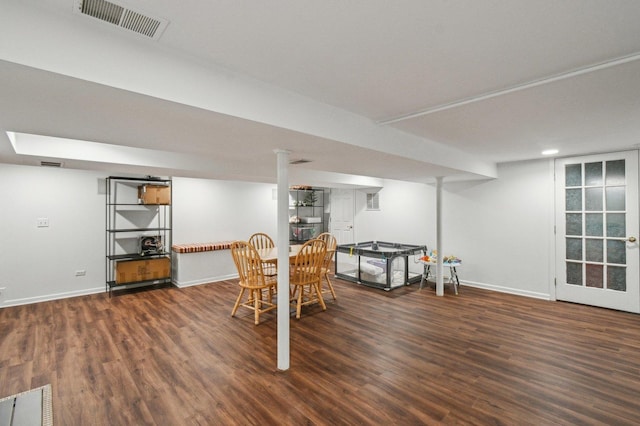 dining room with baseboards, visible vents, and wood finished floors