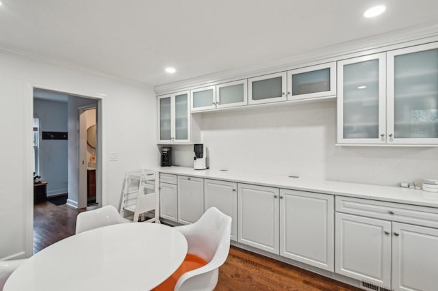 kitchen with crown molding, recessed lighting, dark wood finished floors, and light countertops