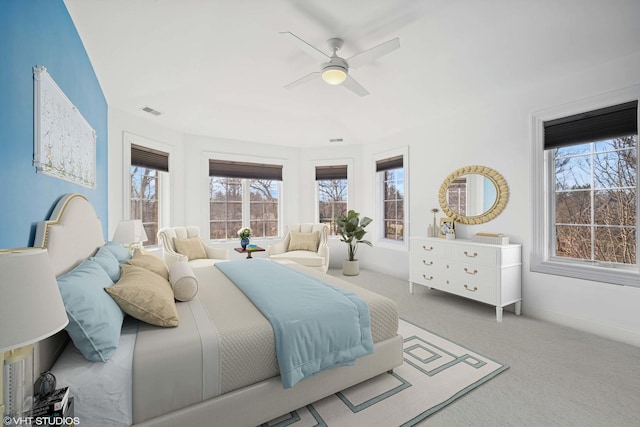 bedroom featuring visible vents, baseboards, a ceiling fan, and carpet