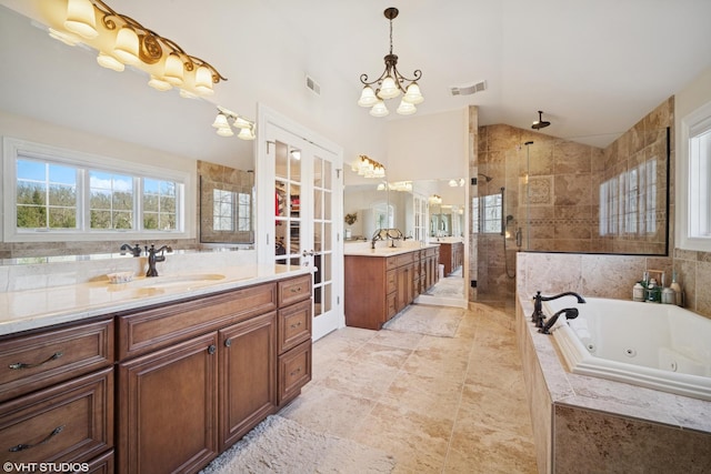 bathroom with visible vents, a notable chandelier, a sink, a shower stall, and lofted ceiling
