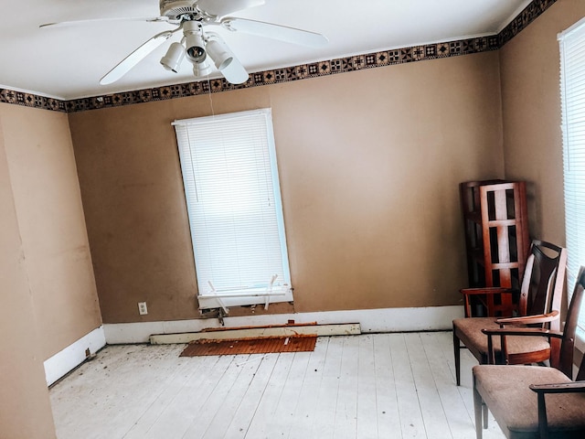 unfurnished room with hardwood / wood-style flooring and ceiling fan
