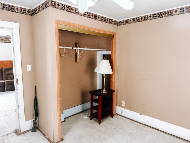 interior space with a closet, baseboards, and ornamental molding