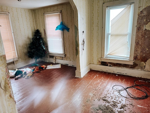 interior space featuring hardwood / wood-style floors and wallpapered walls