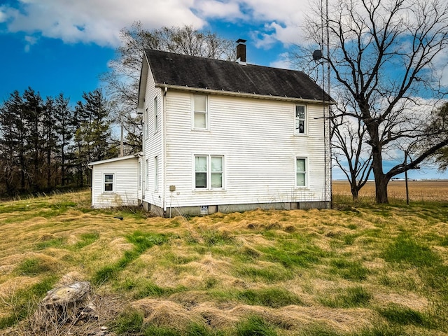 view of home's exterior featuring a chimney