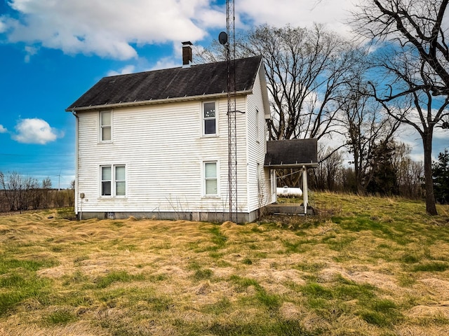 view of side of property featuring a chimney