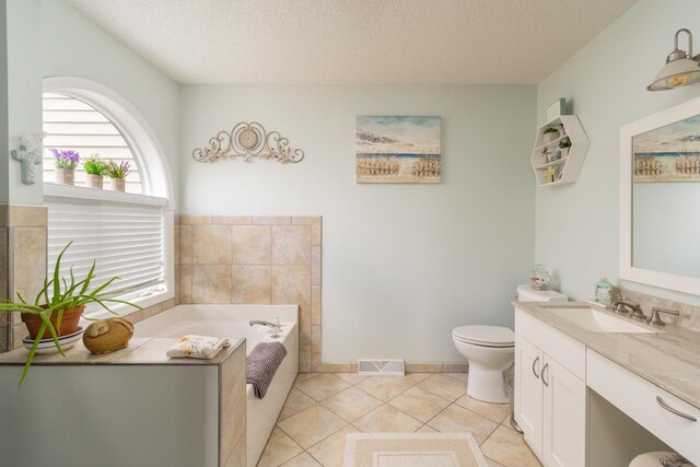 130333020 E St, Spring Valley, IL 61362 - full bathroom featuring a textured ceiling, a garden tub, vanity, toilet, and tile patterned flooring