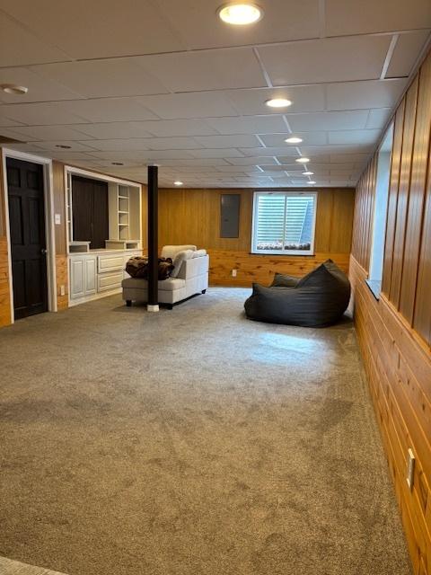 678 Meridian Way, Antioch, IL 60002 - unfurnished living room with wood walls, carpet flooring, and recessed lighting