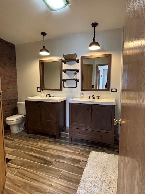 678 Meridian Way, Antioch, IL 60002 - full bathroom featuring two vanities, a sink, wood tiled floor, and toilet