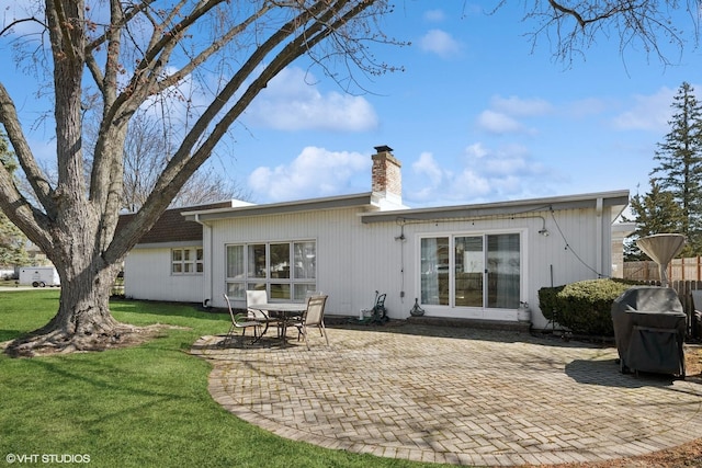 1130 Crestwood Dr, Northbrook, IL 60062 - rear view of house featuring a yard, a patio area, fence, and a chimney