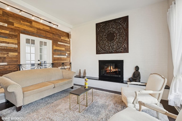 1130 Crestwood Dr, Northbrook, IL 60062 - living room featuring a lit fireplace, wood walls, and rail lighting