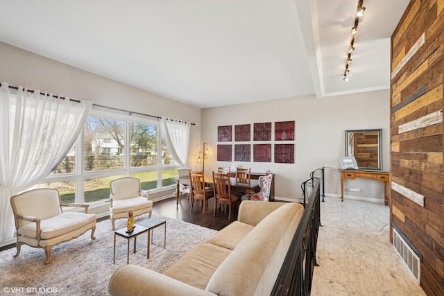 1130 Crestwood Dr, Northbrook, IL 60062 - living area featuring visible vents, baseboards, rail lighting, and wood walls
