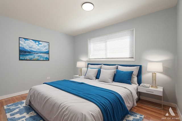 bedroom with wood finished floors and baseboards