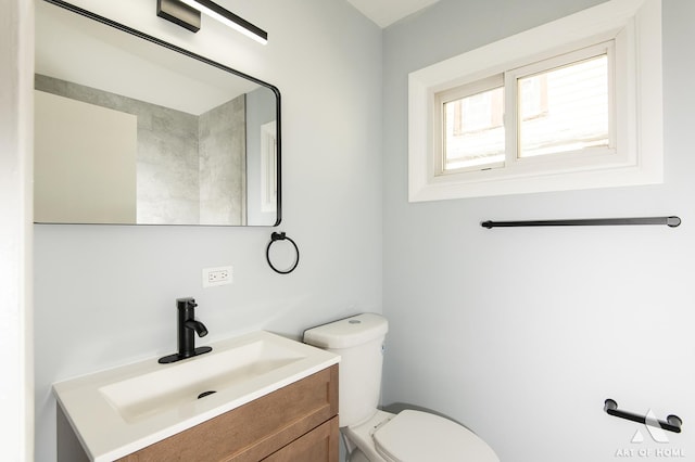 bathroom with toilet and vanity