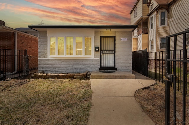view of front of property with fence and stone siding