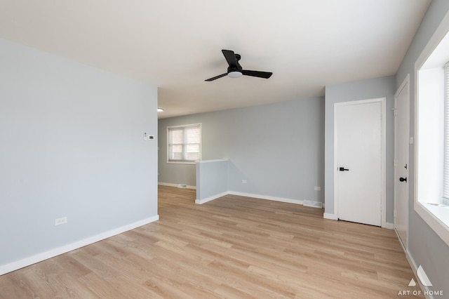 unfurnished room with visible vents, ceiling fan, light wood-type flooring, and baseboards