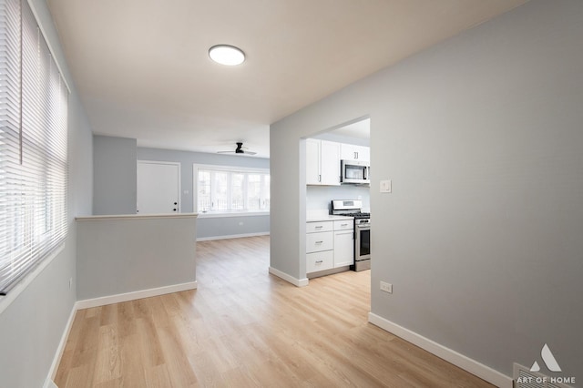 interior space with baseboards and light wood-style floors
