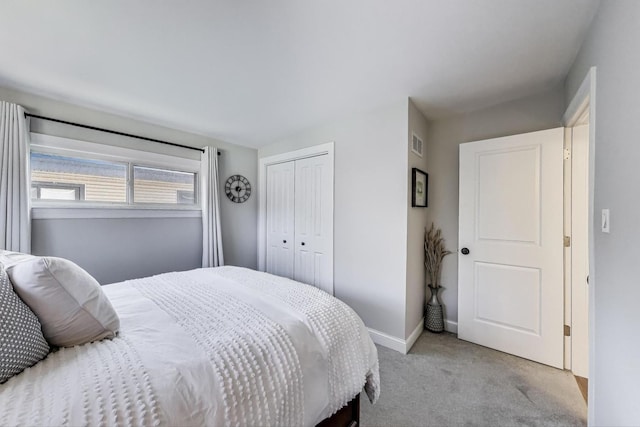 bedroom with a closet, light colored carpet, baseboards, and visible vents