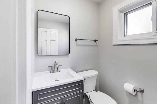 bathroom featuring toilet and vanity