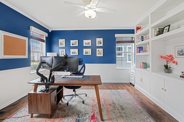 office area featuring crown molding, baseboards, a ceiling fan, and wood finished floors