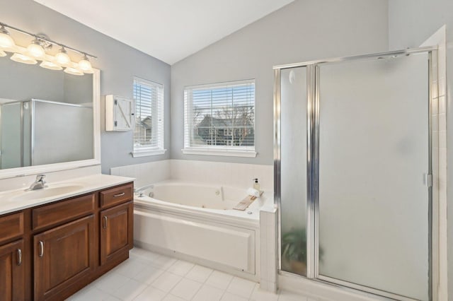 bathroom featuring vanity, vaulted ceiling, tile patterned floors, a shower stall, and a tub with jets