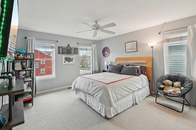 bedroom featuring ceiling fan, baseboards, and carpet floors