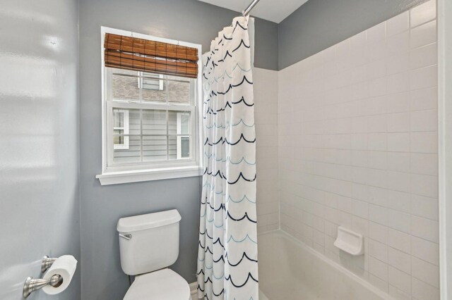 full bathroom with shower / bath combo and toilet