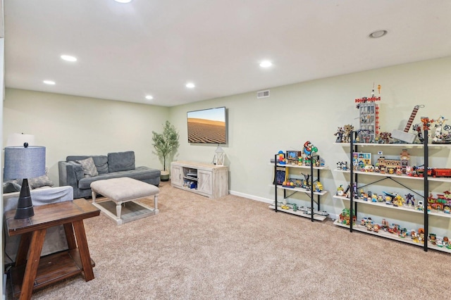 carpeted living room with baseboards, visible vents, and recessed lighting