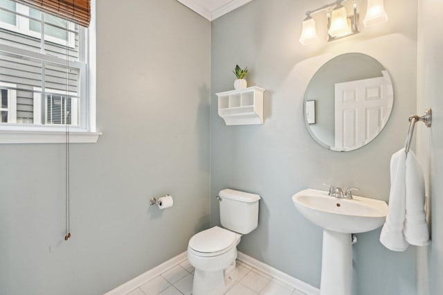 half bathroom featuring tile patterned floors, baseboards, and toilet