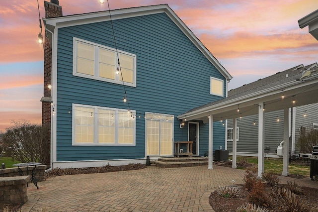 rear view of property featuring a patio and central AC unit