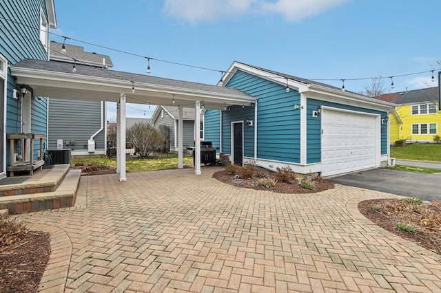 exterior space featuring aphalt driveway and grilling area
