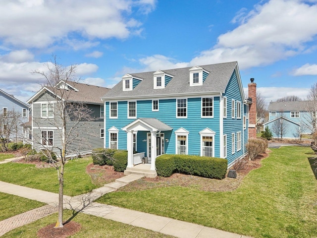 view of front of home featuring a front yard and roof with shingles