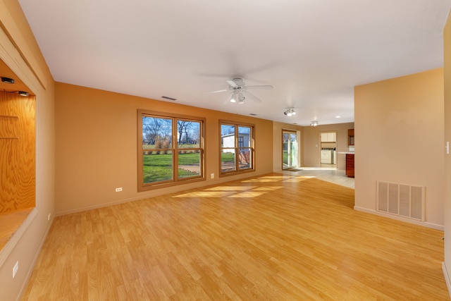 2S154 Lloyd Ave, Lombard, IL 60148 - unfurnished living room featuring baseboards, ceiling fan, light wood-style flooring, and visible vents