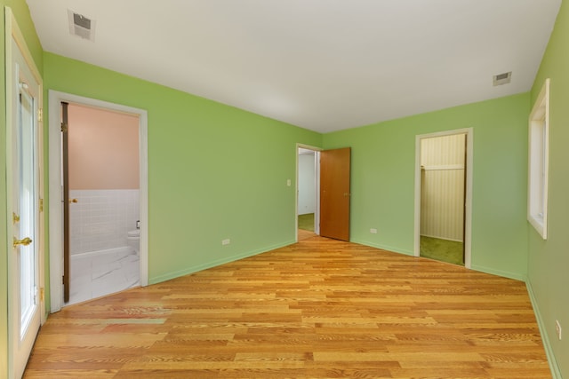 2S154 Lloyd Ave, Lombard, IL 60148 - unfurnished bedroom with visible vents, light wood-style flooring, and ensuite bathroom