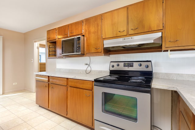 2S154 Lloyd Ave, Lombard, IL 60148 - kitchen featuring light countertops, light tile patterned floors, stainless steel appliances, and under cabinet range hood