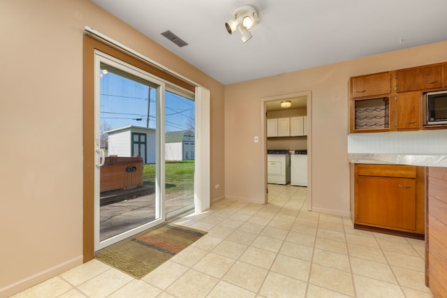 2S154 Lloyd Ave, Lombard, IL 60148 - interior space with visible vents, light countertops, stainless steel microwave, brown cabinets, and separate washer and dryer