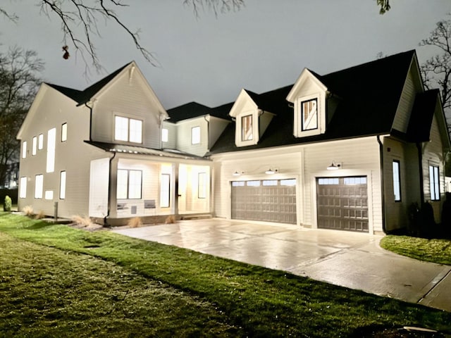 exterior space with a garage, driveway, and a lawn