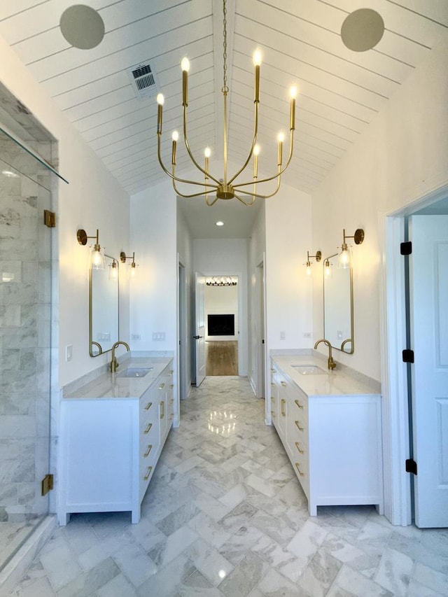 bathroom with a sink, two vanities, and a shower stall
