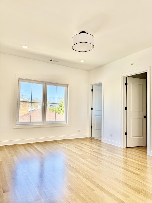unfurnished room with visible vents, baseboards, recessed lighting, and light wood-style floors