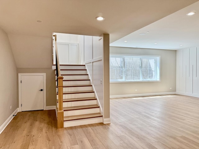 staircase with recessed lighting, baseboards, and wood finished floors